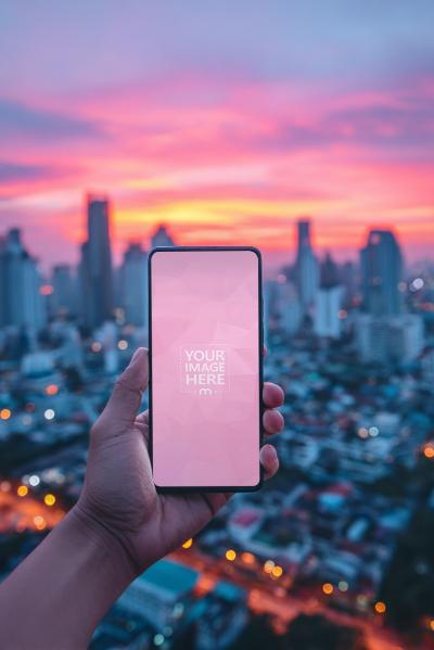 Smartphone Mockup Held Above City at Sunset