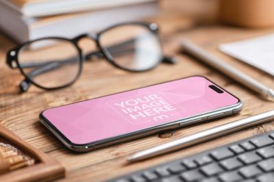 Smartphone Mockup Lying on Wooden Desk with Glasses