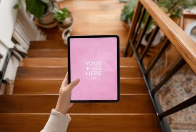 Tablet Mockup Held over Indoor Staircase