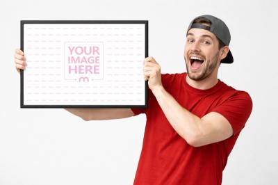 Man Holding Horizontal Picture Frame Mockup in Lifestyle Scene