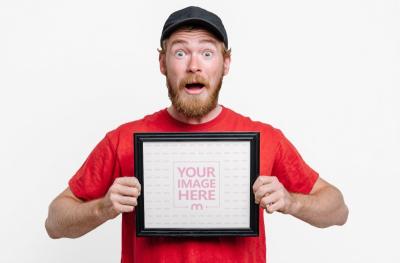 Man Holding Square Black Picture Frame Mockup