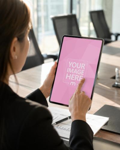 Woman Pointing at Tablet Screen Mockup in Modern Office Meeting